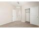Bedroom featuring carpet, a doorway to the bathroom, and a closet with sliding doors at 14355 W Valentine St, Surprise, AZ 85379