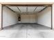 Clean, bright garage with concrete flooring, overhead lighting and plenty of space for parking at 14355 W Valentine St, Surprise, AZ 85379