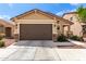 Charming home featuring a two car garage, rock accents and low maintenance landscaping at 14355 W Valentine St, Surprise, AZ 85379