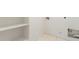 A spacious laundry room area with tile flooring and storage shelves for organization at 14355 W Valentine St, Surprise, AZ 85379