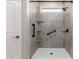 Walk-in shower featuring gray stone wall paneling and modern fixtures at 14355 W Valentine St, Surprise, AZ 85379