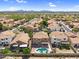 Aerial neighborhood view highlighting the lush desert landscape, refreshing pool, and residential surroundings at 14393 N 101St St, Scottsdale, AZ 85260