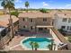 Aerial view of backyard showcasing the pool, covered patio, desert landscaping and the home's layout at 14393 N 101St St, Scottsdale, AZ 85260