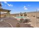 Backyard features pool, BBQ, covered patio, and desert landscaping at 14393 N 101St St, Scottsdale, AZ 85260