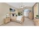 Tranquil bedroom featuring a ceiling fan, ensuite bathroom, and comfortable carpeting at 14393 N 101St St, Scottsdale, AZ 85260