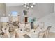 Bright open-concept dining room features tile floors, glass-top table for six, and neutral decor at 14393 N 101St St, Scottsdale, AZ 85260