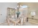 Formal dining area featuring tile flooring, a glass-top dining table and chairs, and cabinet at 14393 N 101St St, Scottsdale, AZ 85260