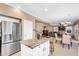Open kitchen featuring an island, stainless steel refrigerator, and seamless flow to dining and living areas at 14393 N 101St St, Scottsdale, AZ 85260