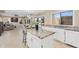 Spacious kitchen featuring an island with seating, granite countertops, and backyard views at 14393 N 101St St, Scottsdale, AZ 85260