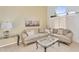 Cozy living room featuring tile flooring, a large window, and comfortable neutral toned sofas and decor at 14393 N 101St St, Scottsdale, AZ 85260