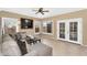 Cozy living room with tile floors, sectional seating, backyard views, and backyard access at 14393 N 101St St, Scottsdale, AZ 85260