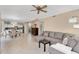 Open concept living room offering tile flooring, a ceiling fan, and a view of the adjacent kitchen at 14393 N 101St St, Scottsdale, AZ 85260