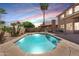 Sparkling pool with cool decking surrounded by lush landscaping and privacy fence at 14393 N 101St St, Scottsdale, AZ 85260