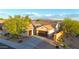 Aerial view of home with a landscaped yard and mountain views at 16229 W Berkeley Rd, Goodyear, AZ 85395
