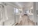 Bathroom with a soaking tub, glass enclosed shower, and dual sink vanity at 16229 W Berkeley Rd, Goodyear, AZ 85395