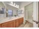 Bathroom features a double sink vanity, large mirror, and a shower and tub combo at 16229 W Berkeley Rd, Goodyear, AZ 85395