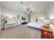 Open main bedroom area featuring a ceiling fan, television and sliding glass door at 16229 W Berkeley Rd, Goodyear, AZ 85395
