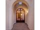 Arched entryway with a security gate and decorative lighting at 16229 W Berkeley Rd, Goodyear, AZ 85395