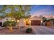 Charming home featuring manicured landscaping, a two-car garage, and a welcoming entrance at 16229 W Berkeley Rd, Goodyear, AZ 85395