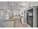 Open-concept kitchen with stainless steel appliances, a center island, and natural light at 16229 W Berkeley Rd, Goodyear, AZ 85395