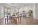 Bright kitchen features white cabinetry, stainless steel appliances, and a wood dining table with bench seating at 16229 W Berkeley Rd, Goodyear, AZ 85395