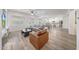 Open-concept living area showcasing stylish furniture, wood-look floors, and a view into the kitchen at 16229 W Berkeley Rd, Goodyear, AZ 85395
