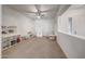 The play room features neutral carpet, ceiling fan, natural light, and furniture at 16229 W Berkeley Rd, Goodyear, AZ 85395