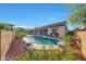 Backyard pool and patio with manicured landscaping and outdoor seating at 16229 W Berkeley Rd, Goodyear, AZ 85395