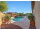 Beautiful backyard pool with rock accents and lush landscaping at 16229 W Berkeley Rd, Goodyear, AZ 85395