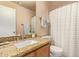 Well-lit bathroom featuring granite countertops, a modern sink, and a shower with a patterned curtain at 16274 N 138Th Ln, Surprise, AZ 85374