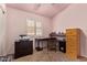 Functional bedroom featuring a desk, dresser, and bright window, perfect for a home office or guest room at 16274 N 138Th Ln, Surprise, AZ 85374