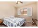 Comfortable bedroom features a ceiling fan, neutral walls, and a bright window with white shutters at 16274 N 138Th Ln, Surprise, AZ 85374