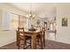 Charming dining area with a wood table set, and an open view to the living space at 16274 N 138Th Ln, Surprise, AZ 85374