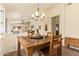 The dining area offers an inviting ambiance with its rustic wood table set and stylish chandelier at 16274 N 138Th Ln, Surprise, AZ 85374