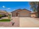 Charming single-story home featuring a neutral color scheme, well-maintained landscaping, and an attached two-car garage at 16274 N 138Th Ln, Surprise, AZ 85374