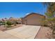 Inviting front exterior showcasing a well-maintained yard and a spacious driveway, creating a welcoming curb appeal at 16274 N 138Th Ln, Surprise, AZ 85374