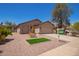 Well-maintained single-story home with desert landscaping, grassy area and attached two-car garage at 16274 N 138Th Ln, Surprise, AZ 85374