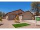 Well-maintained single-story home with desert landscaping, grassy area and attached two-car garage at 16274 N 138Th Ln, Surprise, AZ 85374