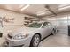 Spacious garage with ample storage shelves and a parked car, offering practical storage and parking solutions at 16274 N 138Th Ln, Surprise, AZ 85374