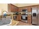 Well-appointed kitchen features stainless steel appliances, granite countertops, and wood cabinetry at 16274 N 138Th Ln, Surprise, AZ 85374