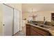 Bright kitchen features stainless steel sink, granite countertops, and a view to the backyard at 16274 N 138Th Ln, Surprise, AZ 85374