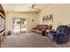Inviting living room featuring comfortable seating, a ceiling fan, and a sliding glass door to the patio at 16274 N 138Th Ln, Surprise, AZ 85374