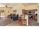 Open concept living room with a kitchen, tile floors, ceiling fan and comfortable seating at 16274 N 138Th Ln, Surprise, AZ 85374