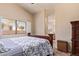 Comfortable main bedroom features a large window with natural light and an ensuite bathroom at 16274 N 138Th Ln, Surprise, AZ 85374