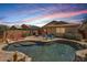 Inviting backyard oasis with a private pool, patio, and lush landscaping at 17244 W Mohave St, Goodyear, AZ 85338