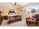 Cozy bedroom showcasing a wooden bed frame and a comfortable chair near the window at 17244 W Mohave St, Goodyear, AZ 85338