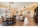 Bright dining space with modern lighting and views of the living room and front yard at 17244 W Mohave St, Goodyear, AZ 85338