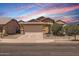 Charming single-story home featuring a well-manicured front yard, driveway, and two-car garage at 17244 W Mohave St, Goodyear, AZ 85338