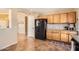 The kitchen features wooden cabinets, granite countertops, and modern black appliances at 17244 W Mohave St, Goodyear, AZ 85338