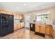 Bright kitchen featuring wooden cabinets, granite countertops, and a view of the outdoor space at 17244 W Mohave St, Goodyear, AZ 85338